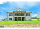 Rear view of home featuring large windows, a covered patio, and a spacious lawn at 120 Lapis Lake Pt, Fayetteville, GA 30215