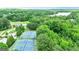 Aerial view of tennis courts in a lush, green community near a lake and clubhouse with beautiful landscape at 120 Lapis Lake Pt, Fayetteville, GA 30215