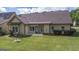 This backyard has a well-maintained lawn, shrubs, and a patio at 474 Strawberry Walk, Loganville, GA 30052