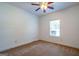 Bright bedroom with carpet, ceiling fan, and a window offering a peaceful view at 474 Strawberry Walk, Loganville, GA 30052
