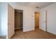 This is a carpeted bedroom that contains two closets with white doors at 474 Strawberry Walk, Loganville, GA 30052