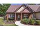 Inviting entryway to home with brick pillars, manicured bushes, and a well-kept lawn at 474 Strawberry Walk, Loganville, GA 30052