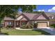 Charming single-story home with manicured lawn, brick accents, and attached two-car garage at 474 Strawberry Walk, Loganville, GA 30052