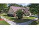 Exterior corner lot with manicured lawn, shrubs, and healthy trees at 474 Strawberry Walk, Loganville, GA 30052