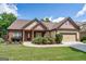 Charming single-Gathering home with brick accents, manicured lawn, and a two-car garage at 474 Strawberry Walk, Loganville, GA 30052