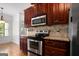 Well-equipped kitchen with stainless appliances, granite countertops, and hardwood floors at 474 Strawberry Walk, Loganville, GA 30052