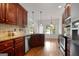 Modern kitchen featuring granite counters, stainless steel appliances, and hardwood floors at 474 Strawberry Walk, Loganville, GA 30052