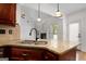 Gourmet kitchen featuring granite countertops, stainless steel sink, and designer lighting at 474 Strawberry Walk, Loganville, GA 30052