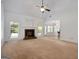 Bright living room with large fireplace and open floor plan, connecting to kitchen area at 474 Strawberry Walk, Loganville, GA 30052