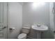 The powder room has tile flooring and a pedestal sink at 474 Strawberry Walk, Loganville, GA 30052
