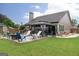Lush backyard features a patio with a fire pit, outdoor seating, and landscaped surroundings for relaxation and enjoyment at 2256 Long Bow Chase Nw, Kennesaw, GA 30144