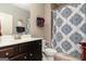 Bathroom with a vanity, decorated mirror, and a shower/tub combo with a decorative blue patterned curtain at 2256 Long Bow Chase Nw, Kennesaw, GA 30144