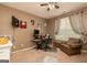 Cozy bedroom featuring a ceiling fan, window, and desk with computer, creating a functional workspace at 2256 Long Bow Chase Nw, Kennesaw, GA 30144