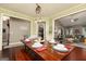 Dining table fully decorated and set, featuring an open view into the living room at 2256 Long Bow Chase Nw, Kennesaw, GA 30144