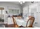 Inviting dining area with wood floors and natural light, furnished with seating for four at 2256 Long Bow Chase Nw, Kennesaw, GA 30144