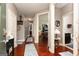 Hallway with hardwood floors, neutral paint, and several open doors at 2256 Long Bow Chase Nw, Kennesaw, GA 30144