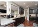 Kitchen with stainless appliances, granite countertops, dark wood cabinets and island view to living room at 2256 Long Bow Chase Nw, Kennesaw, GA 30144