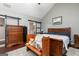 Comfortable bedroom with wood floors, gray walls, and accent bench, with a barn door leading to bath at 2256 Long Bow Chase Nw, Kennesaw, GA 30144