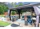 Beautiful outdoor patio area features a covered lounge, stylish furniture, and cozy ambiance, perfect for entertaining at 2256 Long Bow Chase Nw, Kennesaw, GA 30144