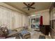 Relaxing sunroom filled with light, features a ceiling fan, tile floor and wicker furniture at 2256 Long Bow Chase Nw, Kennesaw, GA 30144