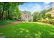 Expansive backyard with lush green lawn and mature trees, perfect for outdoor enjoyment at 162 Daltree Ct, Marietta, GA 30068