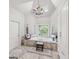 Bright bathroom features a vaulted ceiling, chandelier, and oversized tub under a stained glass window at 162 Daltree Ct, Marietta, GA 30068
