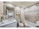 Neutral bathroom showcasing a marble vanity, large mirror, and a shower-tub combo with stylish tile accents at 162 Daltree Ct, Marietta, GA 30068
