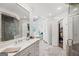 Bright bathroom boasts marble tile, a glass shower, and luxurious finishes at 162 Daltree Ct, Marietta, GA 30068