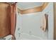 Bright bathroom with white tiled walls and a tub/shower combination at 162 Daltree Ct, Marietta, GA 30068