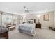 Comfortable bedroom with a ceiling fan, sitting area, bedside tables, and plush carpeting at 162 Daltree Ct, Marietta, GA 30068
