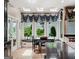 Bright breakfast nook with large windows, built-in seating, and a view of the lush backyard at 162 Daltree Ct, Marietta, GA 30068