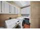 Well-equipped laundry room with modern washer and dryer, ample storage cabinets, and a practical folding area at 162 Daltree Ct, Marietta, GA 30068