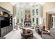 Living room with soaring windows, coffered ceilings, fireplace and elegant furniture at 162 Daltree Ct, Marietta, GA 30068