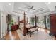 Spacious main bedroom with a four-poster bed, tray ceiling and access to a balcony at 162 Daltree Ct, Marietta, GA 30068