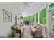 Screened-in patio with comfortable seating, ceiling fan, and a view of the lush backyard at 162 Daltree Ct, Marietta, GA 30068