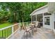 Inviting screened patio with slate flooring, seating, and a grill, perfect for outdoor relaxation and entertaining at 162 Daltree Ct, Marietta, GA 30068