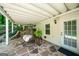 Charming covered patio with stone flooring and hanging egg chair at 162 Daltree Ct, Marietta, GA 30068