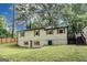 Backyard features a fenced yard, mature trees, and deck access at 500 Pomona Circle Sw, Atlanta, GA 30315