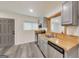 This updated kitchen features stylish gray cabinets, sleek appliances, and a butcher block countertop at 500 Pomona Circle Sw, Atlanta, GA 30315