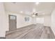 Open-concept living room showcasing modern flooring, a gray front door, ceiling fan, and access to other spaces at 500 Pomona Circle Sw, Atlanta, GA 30315