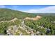 An aerial shot showcases the community nestled near the mountain with beautiful tree coverage and mountain views at 1210 Magnolia Park Cir, Cumming, GA 30040