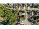 An aerial view shows the property and surrounding homes, roads and green spaces in this suburban neighborhood at 1210 Magnolia Park Cir, Cumming, GA 30040