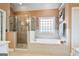 Bright bathroom featuring a shower, soaking tub, and natural light at 1210 Magnolia Park Cir, Cumming, GA 30040