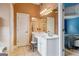 Bathroom with a white vanity, marble countertop, and access to bedroom at 1210 Magnolia Park Cir, Cumming, GA 30040