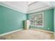 Bedroom with teal walls and a large window at 1210 Magnolia Park Cir, Cumming, GA 30040
