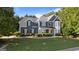 Charming two-story home with manicured lawn, stylish blue siding, and beautiful stone accents at 1210 Magnolia Park Cir, Cumming, GA 30040