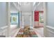 Inviting foyer with colorful accent walls, decorative columns, and view to front door at 1210 Magnolia Park Cir, Cumming, GA 30040