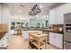Bright kitchen featuring white cabinetry, granite countertops, a stainless steel refrigerator, and light hardwood flooring at 1210 Magnolia Park Cir, Cumming, GA 30040