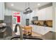 Updated kitchen with dark granite countertops, light cabinetry, a mobile kitchen island, and stainless steel appliances at 1210 Magnolia Park Cir, Cumming, GA 30040