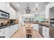 Spacious kitchen boasts white cabinetry, granite countertops, stainless appliances, and a kitchen island at 1210 Magnolia Park Cir, Cumming, GA 30040